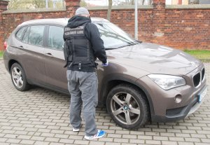 Fot. MOSG Funkcjonariusz SG przy skradzionym BMW X1.