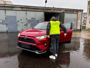 Funkcjonariusz przy czerwonej toyocie. Fot. MOSG Funkcjonariusz przy czerwonej toyocie. Fot. MOSG